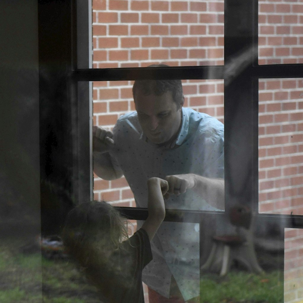 Jason Barnes kommuniziert mit seinem Sohn durch ein Fenster.