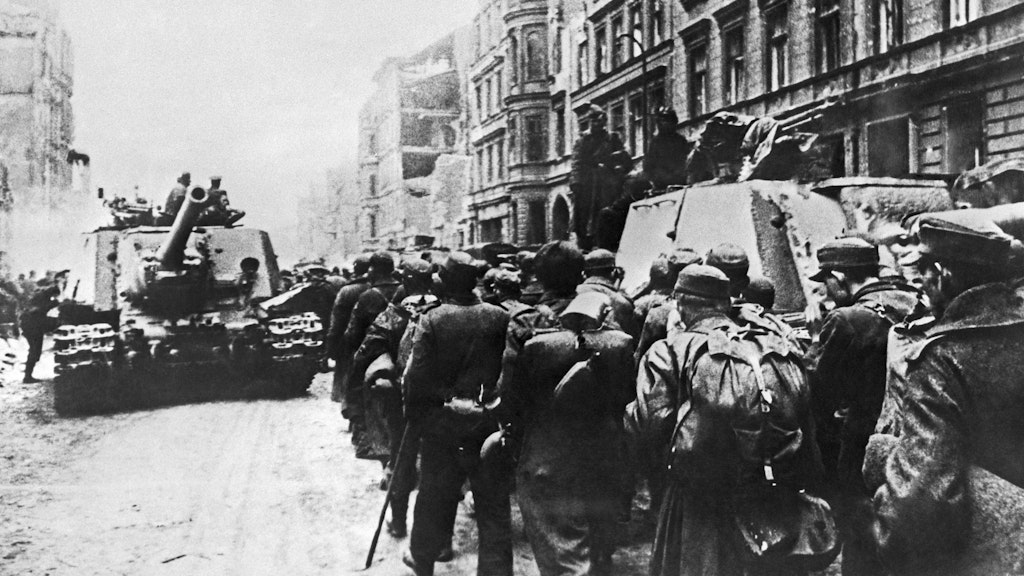 Deutsche Soldaten marschieren auf einer Straße in Berlin in sowjetische Kriegsgefangenschaft. Viele werden nicht zurückkehren.