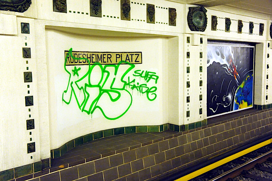 Drei große Buchstaben, sogenannte „Tags“ (Kürzel einer Sprayer-Gang), im U-Bahnhof Rüdesheimer Platz.