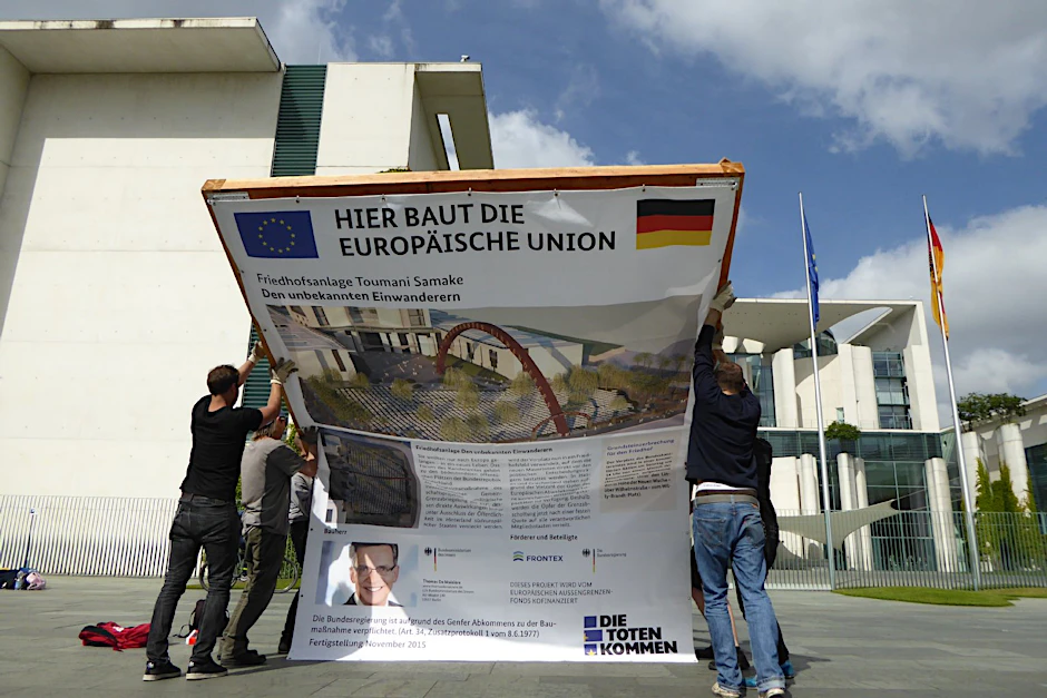 Aktivisten errichten ihr Friedhofs-Bauschild vor dem Kanzleramt.