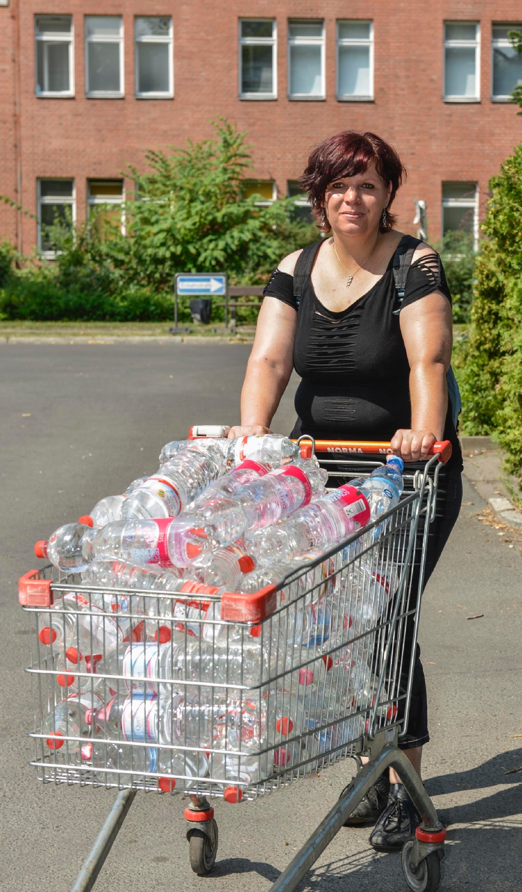 Sandra Schwarze (33) verteilt vor ihrem Dienst bei der Landesarbeitsgemeinschaft Naturschutz Wasserflaschen an die Asylsuchenden. Jeder greift, was er kriegen kann.