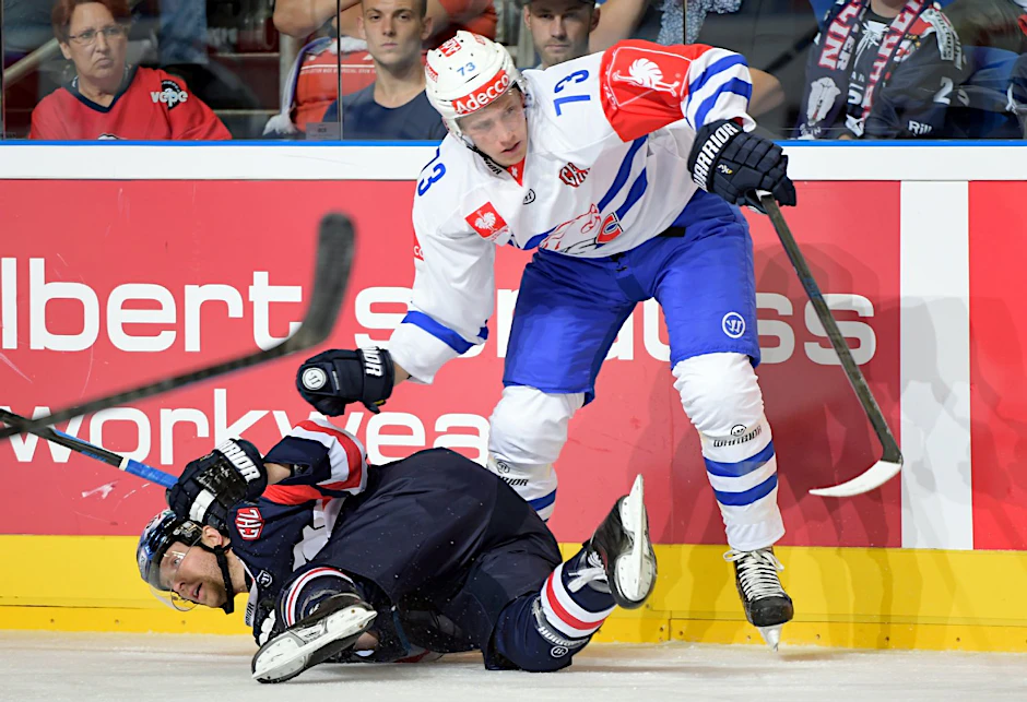 Barry Tallackson von den Eisbären Berlin geht zu Boden gegen Mike Künzle von ZSC Lions Zürich.