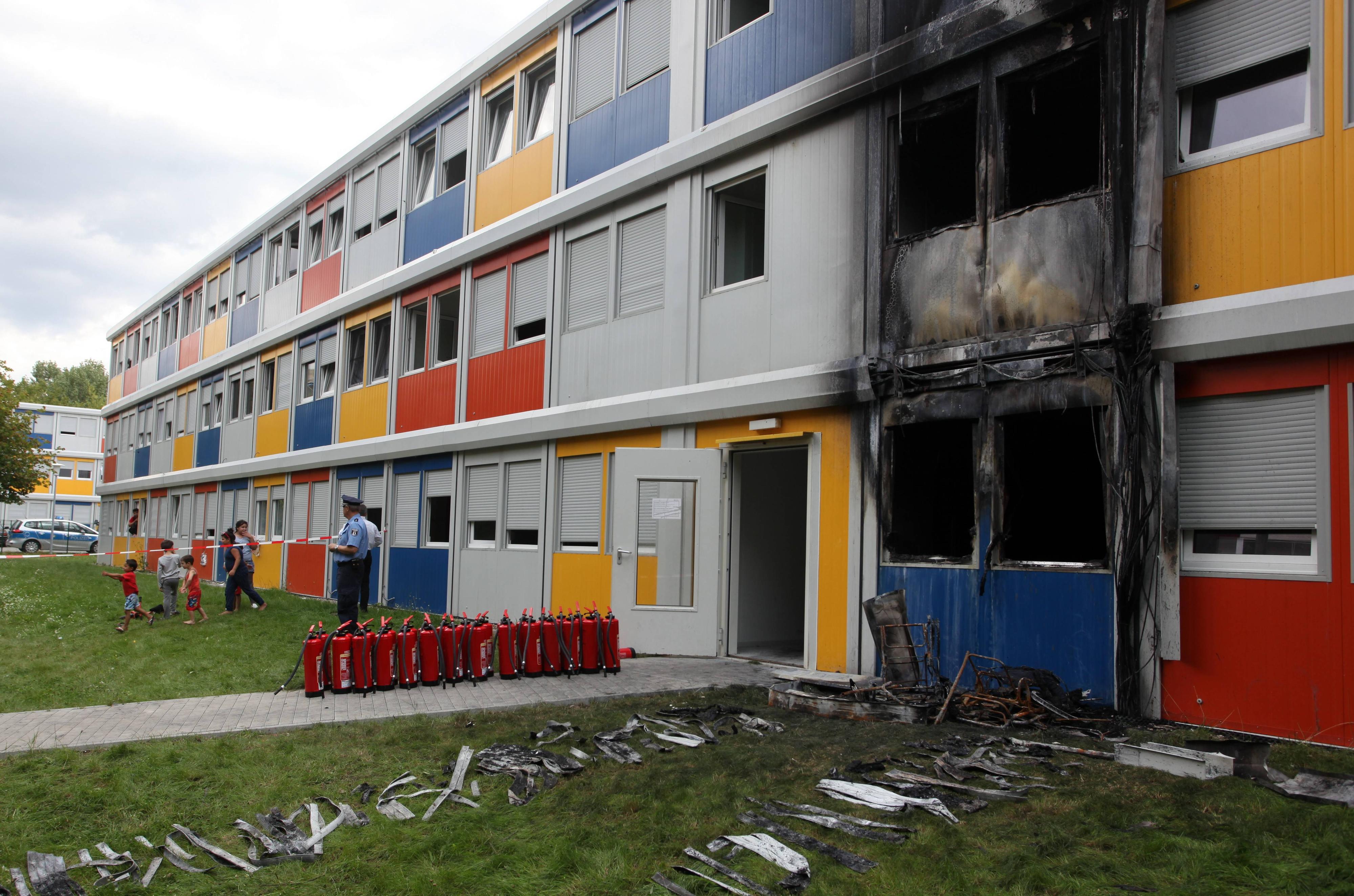 Der Morgen nach dem Brand: Die leeren Feuerwehrlöscher, mit denen die Bewohner den Brand löschen wollten, stehen aufgereiht vor der Tür. 