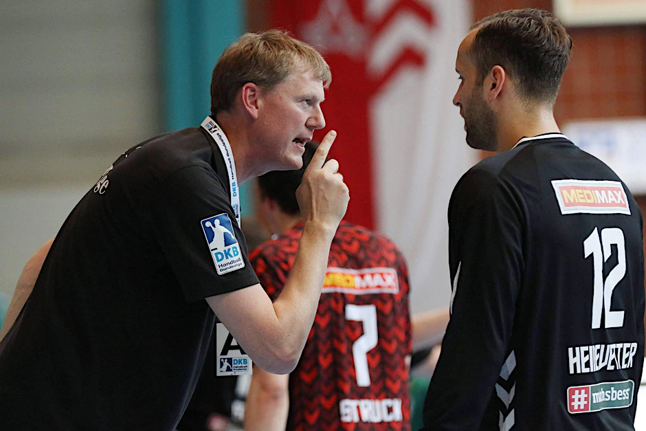 Füchse Sportchef Volker Zerbe ermahnt Torwart Silvio Heinevetter.