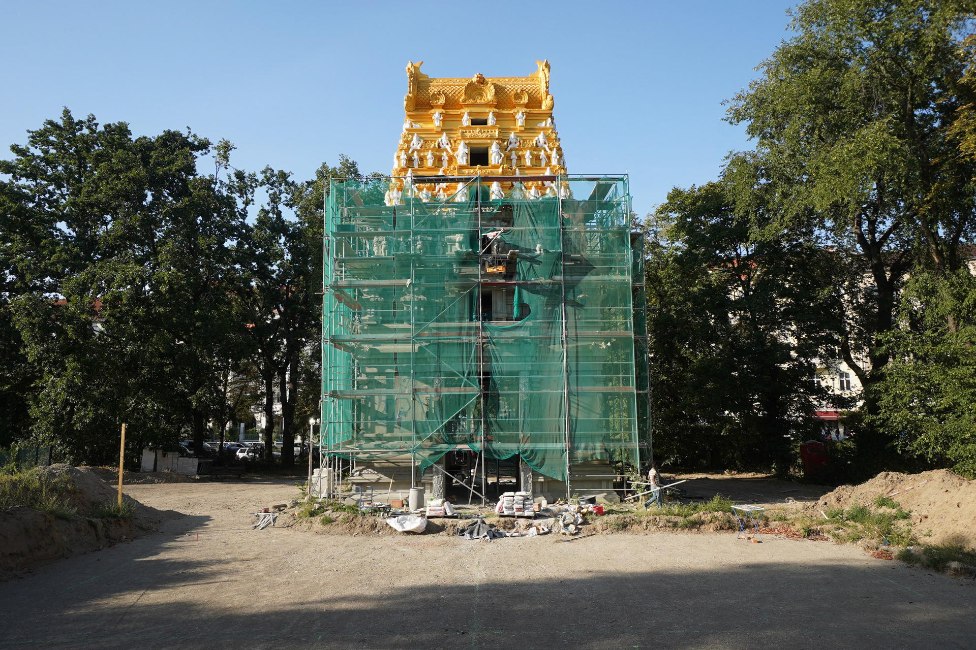 Blick auf das eingerüstete Eingangstor zum demnächst im Vordergrund entstehenden Hindu-Tempel. 