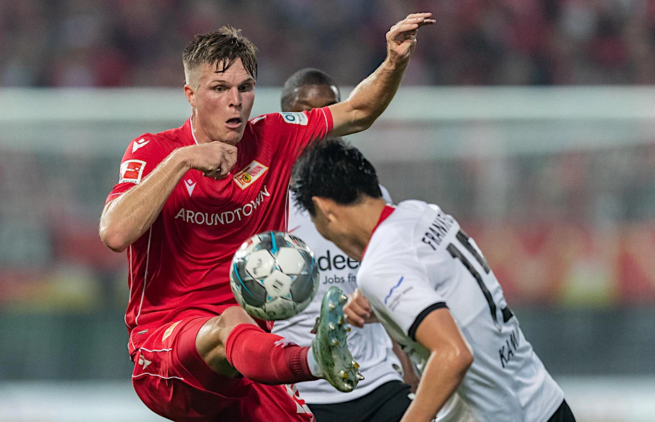 Unions Marius Bülter gibt alles gegen Daichi Kamada.