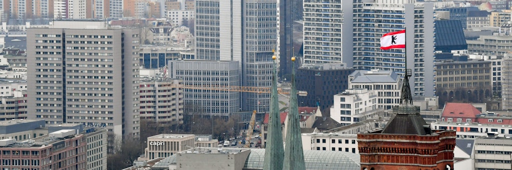 Hinter den Türmen der Marienkirche (l) und des Roten Rathauses sind zahlreiche Wohnblocks zu sehen. 