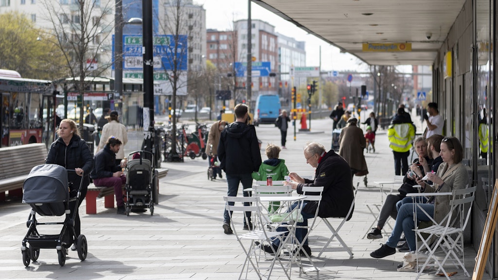 Im schwedischen Stockholm gelten laschere Corona-Regeln als bei uns: Menschen sitzen entspannt im Stadtzentrum vor einem Eiscafé.
