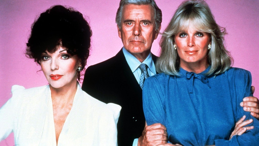 Joan Collins als Alexis Carrington, John Forsythe als ihr geschiedener Mann Blake Carrington und Linda Evans als seine neue Ehefrau Krystle Carrington in der US-Serie „Denver-Clan“