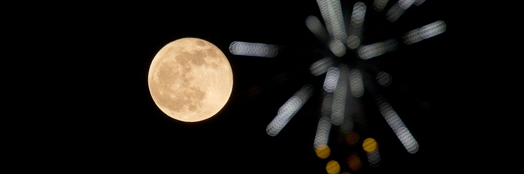Ein Vollmond steht rot am Himmel. Das kann Einfluss auf unser Schlafverhalten haben.