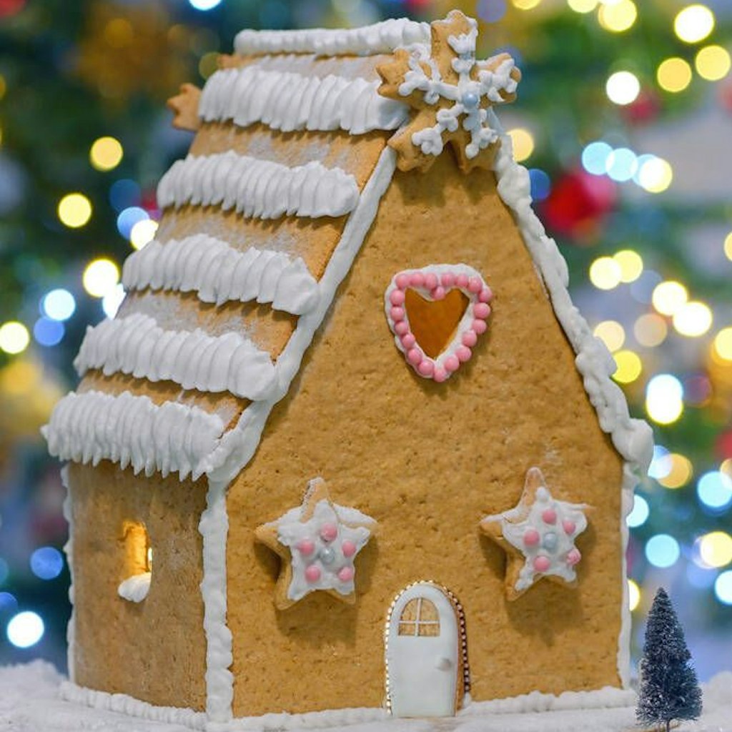 Ein festliches Lebkuchenhaus macht mit einer Deko aus Zuckerguss richtig was her.