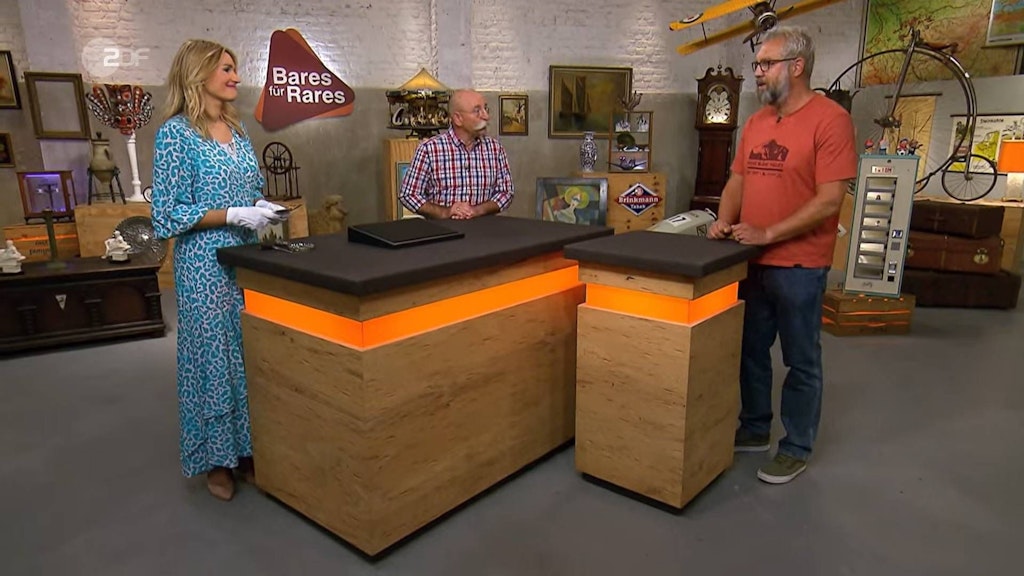 Horst Lichter und Jan Theune lauschen bei „Bares für Rares“ der Expertise von Bianca Berding.