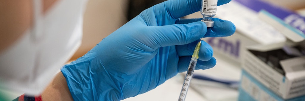Eine Spritze wird mit dem Mittel von Biontech/Pfizer aufgezogen. 