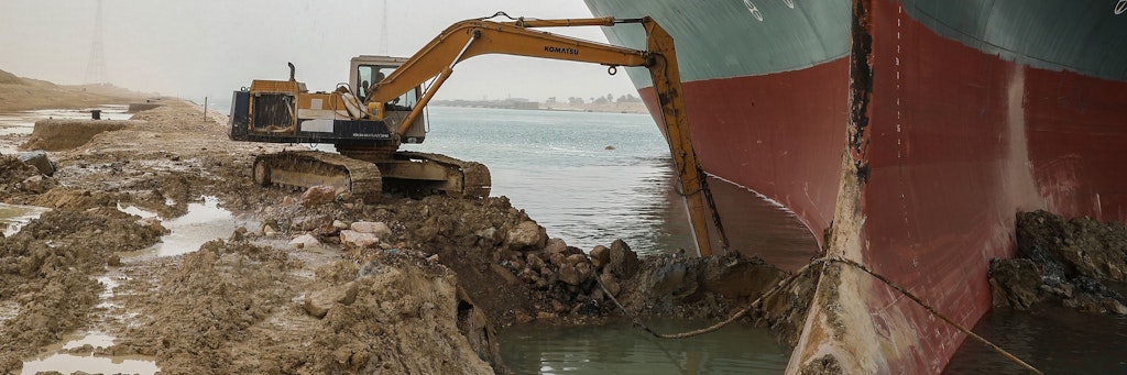Dieses Bild ist Vorlage für viele Memes: Ein Bagger schaufelt Sand am Ufer des Suezkanals, nachdem in der Nacht zum 24. März ein Containerschiff auf Grund gelaufen war.