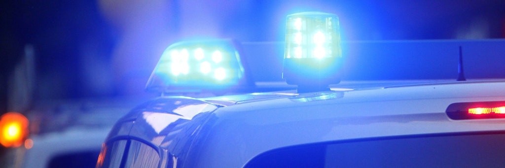 Ein Einsatzwagen der Polizei steht mit Blaulicht an einem Tatort (Symbolbild). 