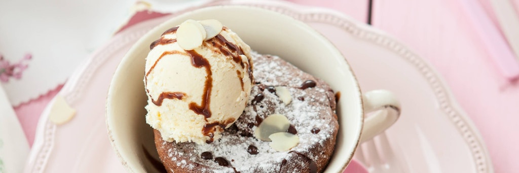 Mit einer Kugel Vanille-Eis ist der schnelle Tassenkuchen einfach perfekt.