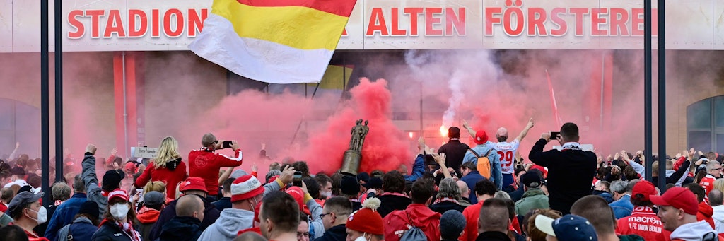 Bierselige Fans feiern ihre Mannschaft ab auf dem Parkplatz vor der Tribüne der Alten Försterei. Union zieht nach Europa ein. 