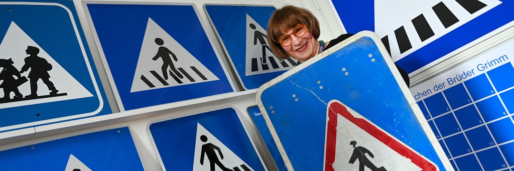 Die Kasseler Künstlerin Doris Gutermuth hält in ihrem Atelier ein Zebrastreifenschild aus Afghanistan in der Hand. 