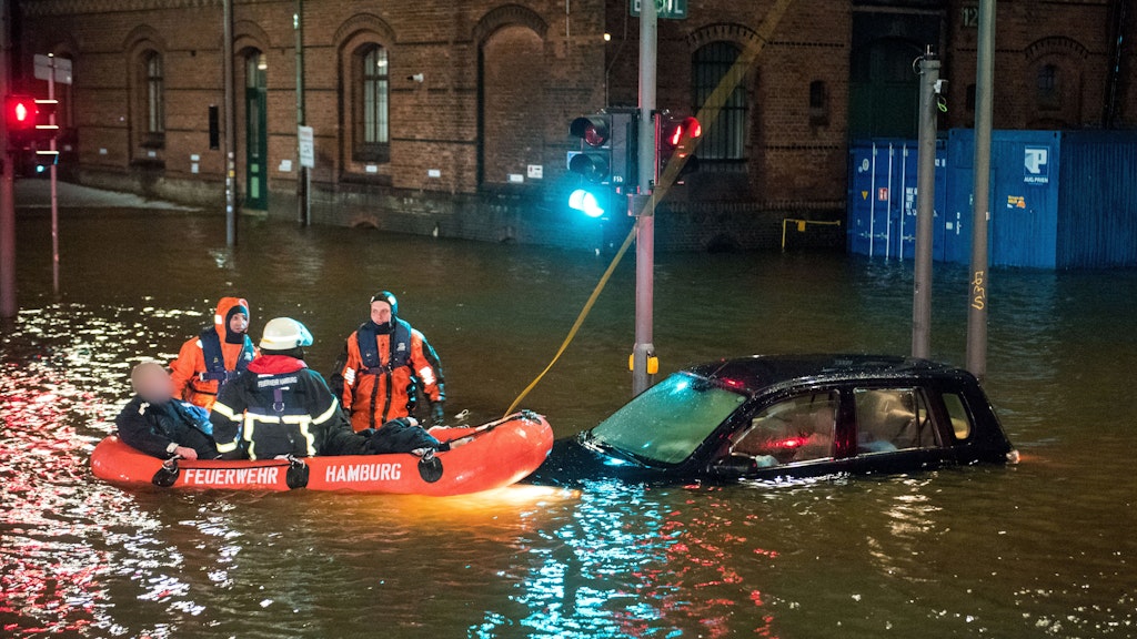Feuerwehrleute retten in der Speicherstadt Hamburg einen Mann aus seinem Auto, der von der Sturmflut beim Hochwasser der Elbe überrascht wurde.