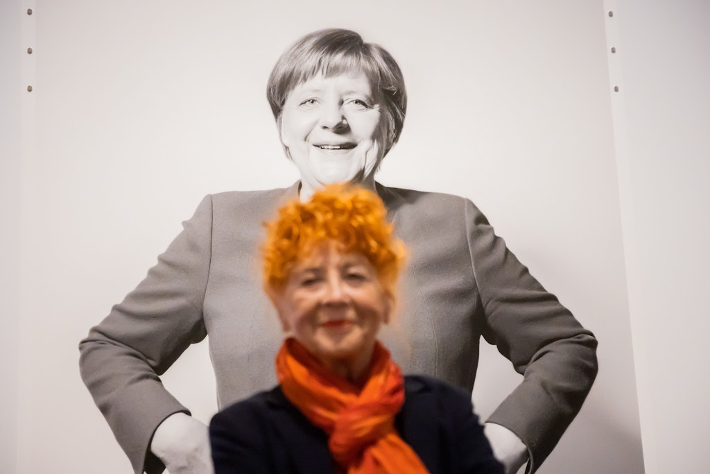 Herlinde Koelbl steht vor einem ihrer Porträts von Angela Merkel im Deutschen Historischen Museum in Berlin.