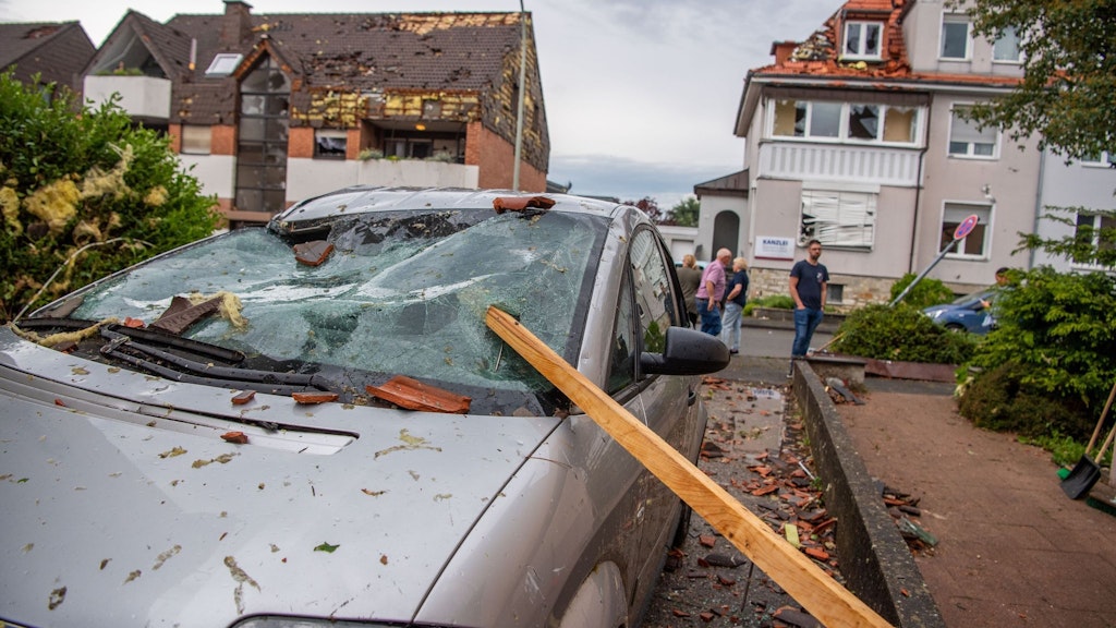 Eine Dachlatte steckt in der Windschutzscheibe eines parkenden Autos. Ein Unwetter hat auch in Paderborn große Schäden angerichtet. Häuser und Autos wurden zerstört.