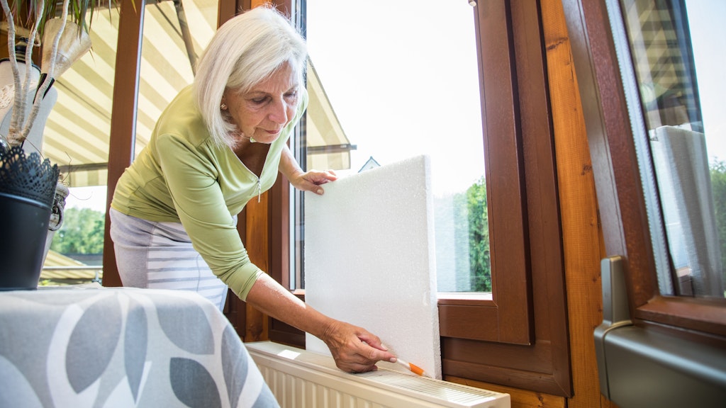 Die Gaspreisbremse drosselt die Heizkosten für Mieter. Um noch mehr zu sparen, können sie die Wand hinter einem Heizkörper mit Dämmstoffplatten isolieren.