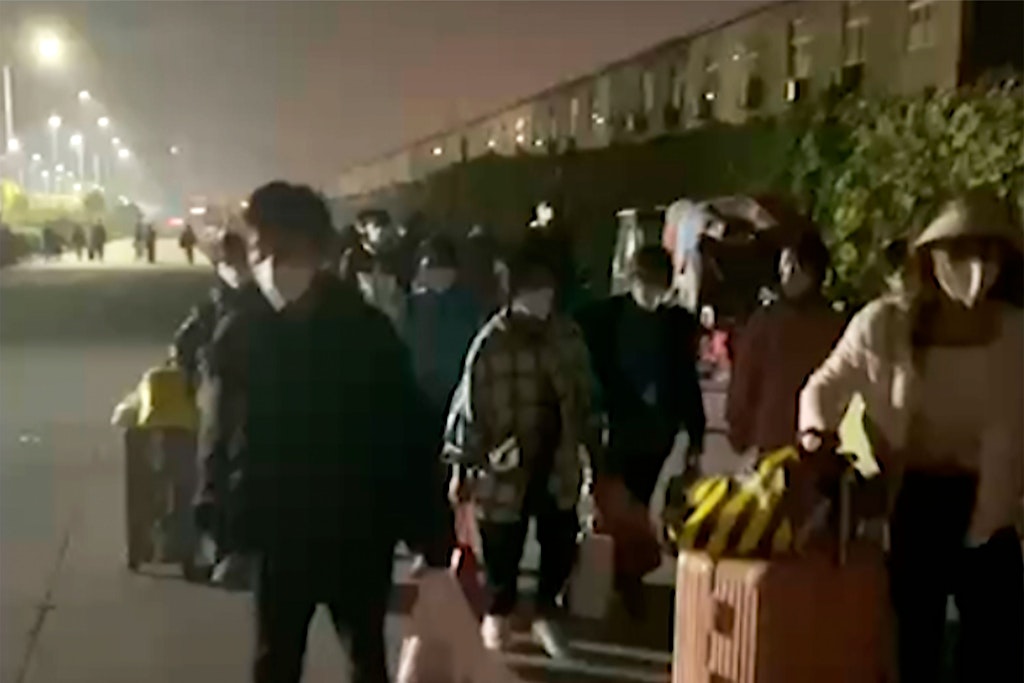 Dieses Bild aus einem Video soll zeigen, wie Mitarbeiter des Apple-Zulieferers Foxconn die Fabrik in Zhengzhou verlassen.
