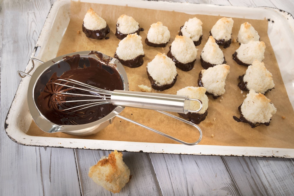 The simplest cookies in the world, delicious coconut macaroons, can be refined with a chocolate coating.