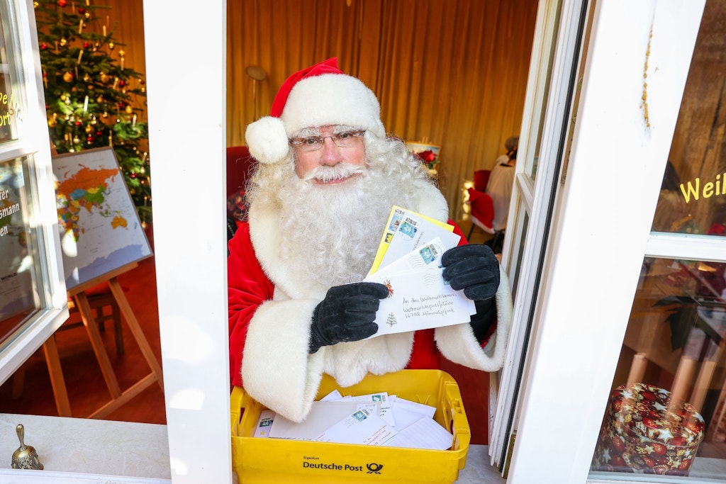 Der Weihnachtsmann hält Briefe von Kindern in Himmelpfort in der Weihnachtspostfiliale. 