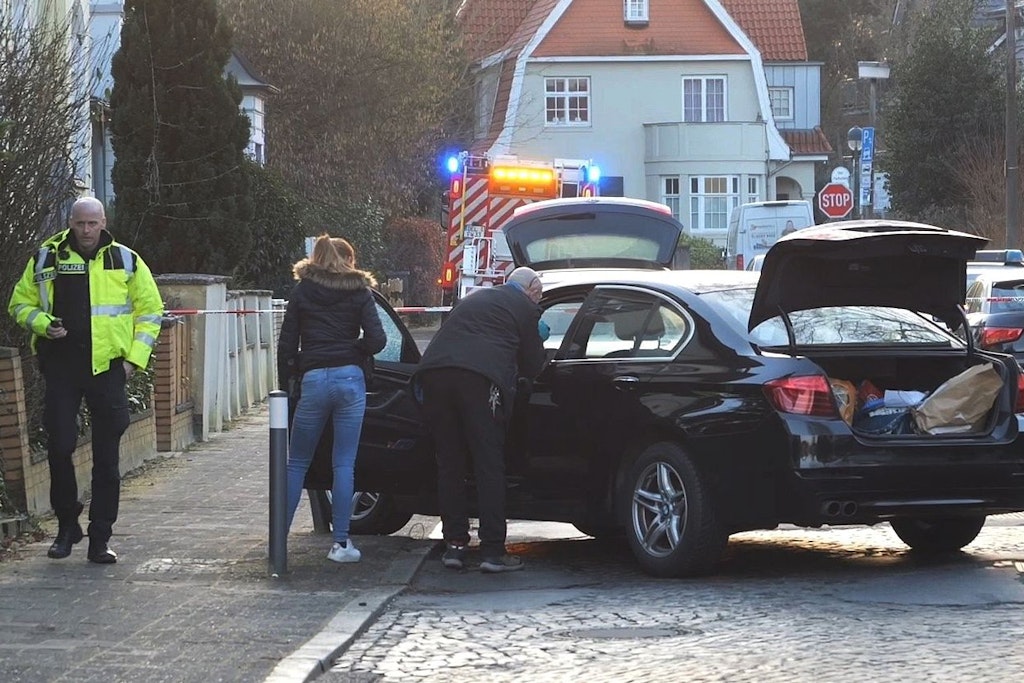 Polizisten untersuchen den PKW, in dem die Frau beschossen wurde.