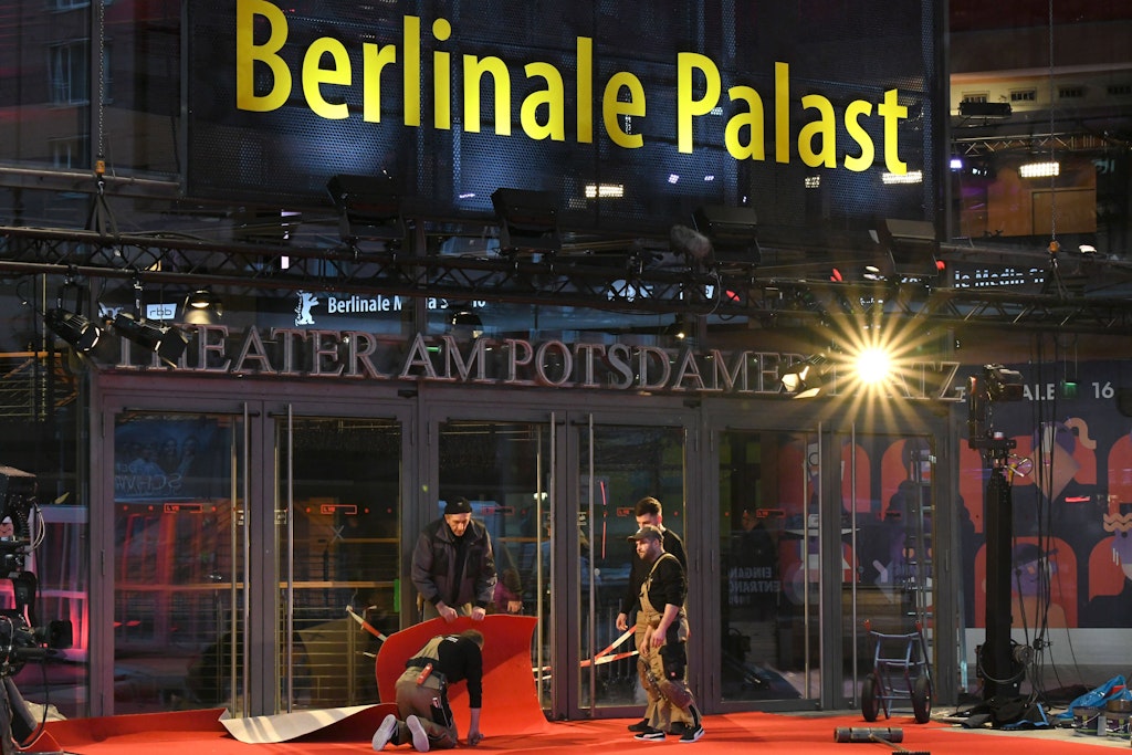 Arbeiter verlegen den roten Teppich vor dem Berlinale Palast am Potsdamer Platz. 