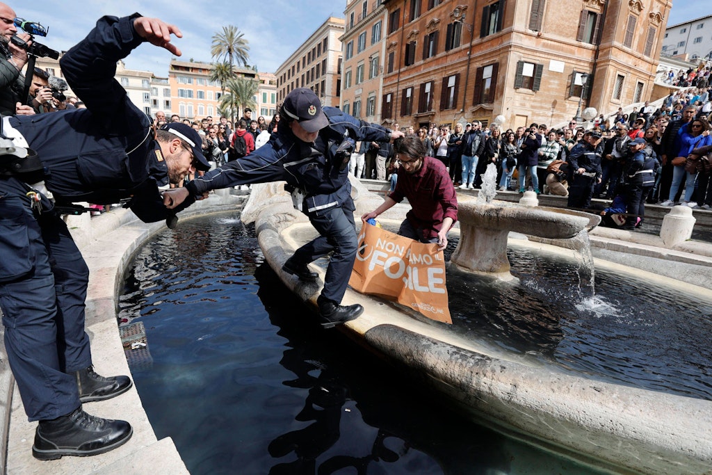 Polizisten holen Klima-Aktivisten aus dem Baraccia-Brunnen in Rom.