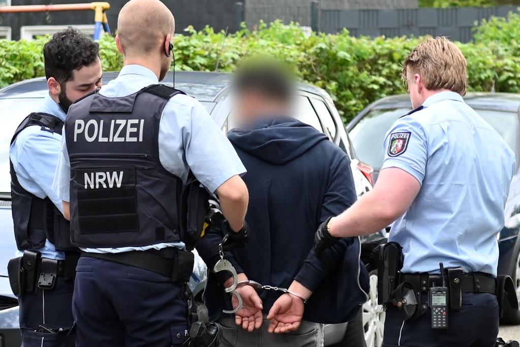 Dorsten: Polizisten führen den Mann ab, der eine Frau in ihrer Wohnung vor den Augen der Kinder niedergestochen hat.