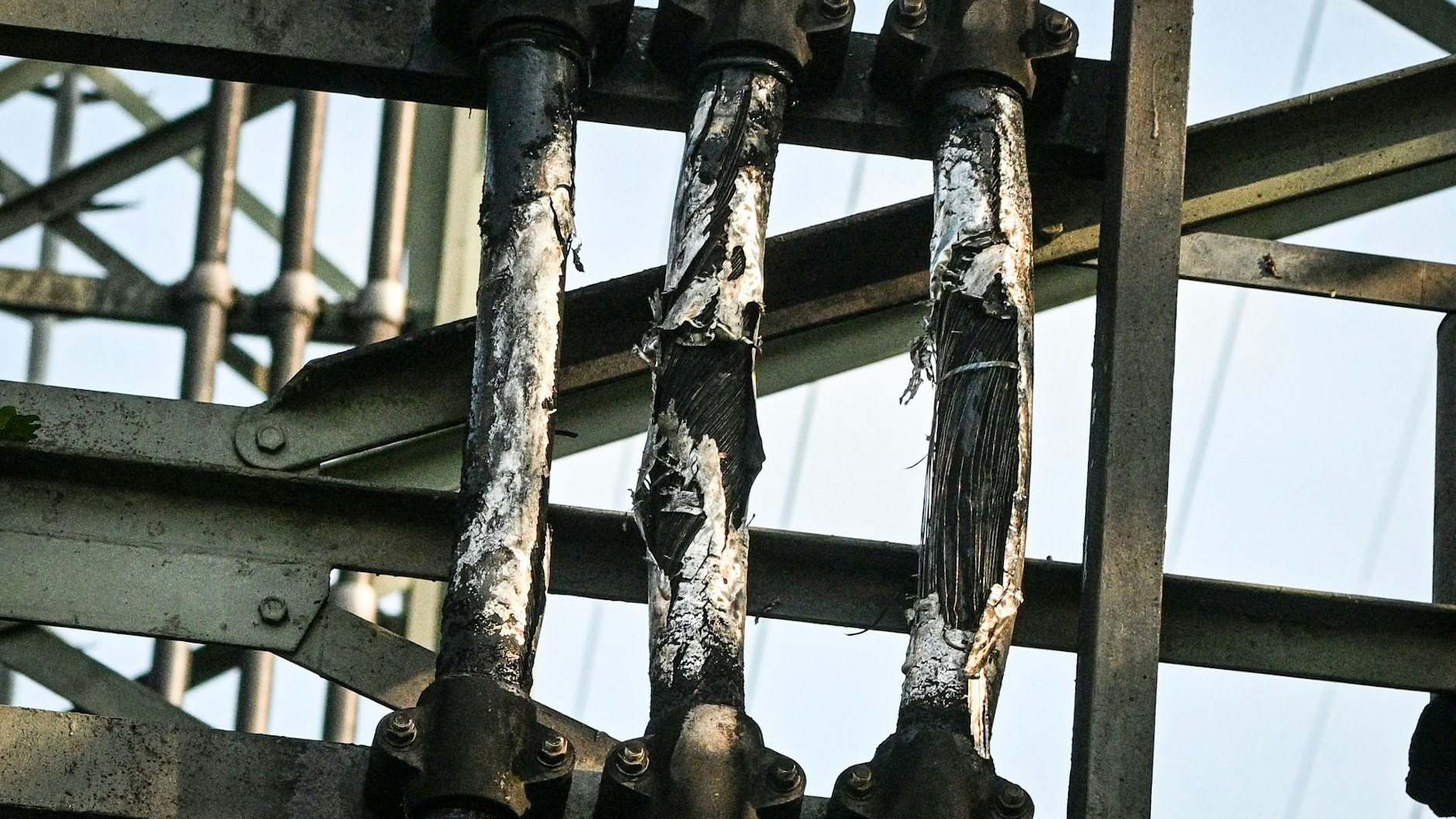 Der teilweise beschädigte Strommast im Königsheideweg. Aufgrund dieses Schadens haben Zehntausende Menschen im Süden Berlins keinen Strom.
